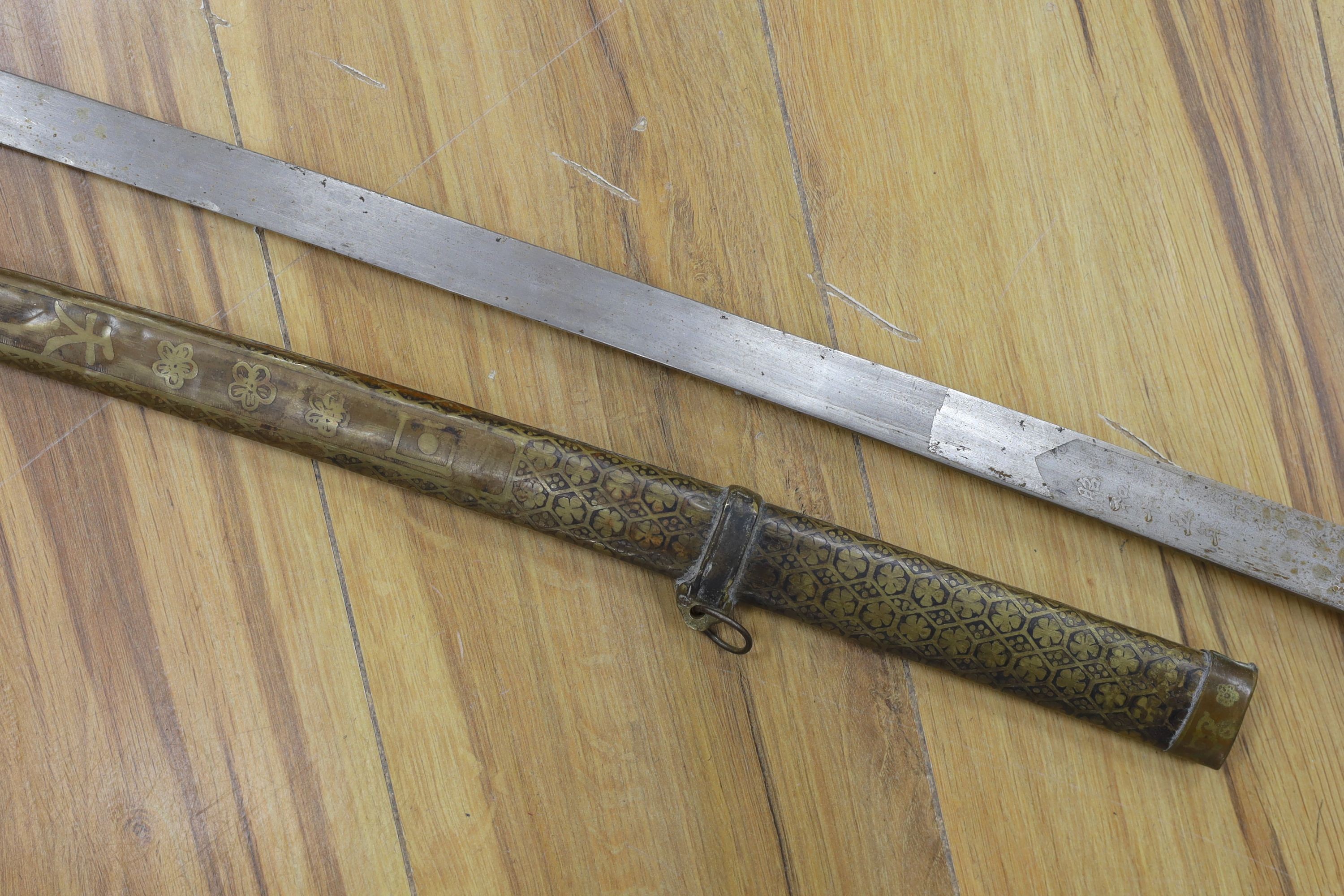 A Chinese sword, single edged blade 64cm long in etched brass scabbard